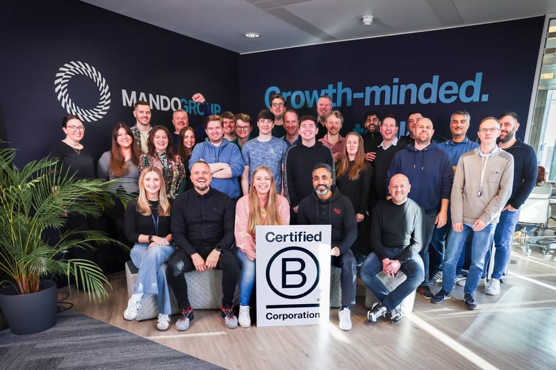 Mando Group team celebrating B Corp